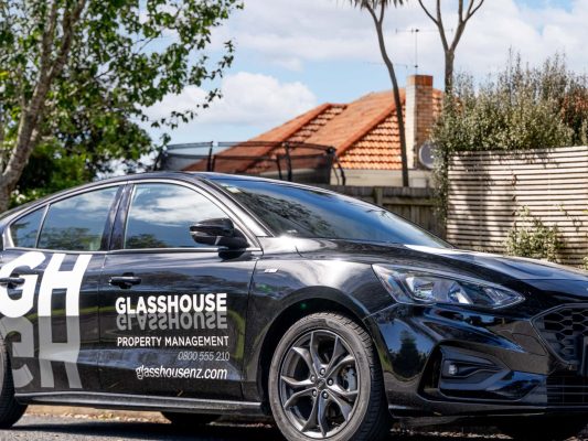 glass house property management company vehicle